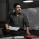 Empresario mexicano analiza un reporte operativo en el piso de su PYME, representando el diagnóstico estratégico previo a la adopción de inteligencia artificial.